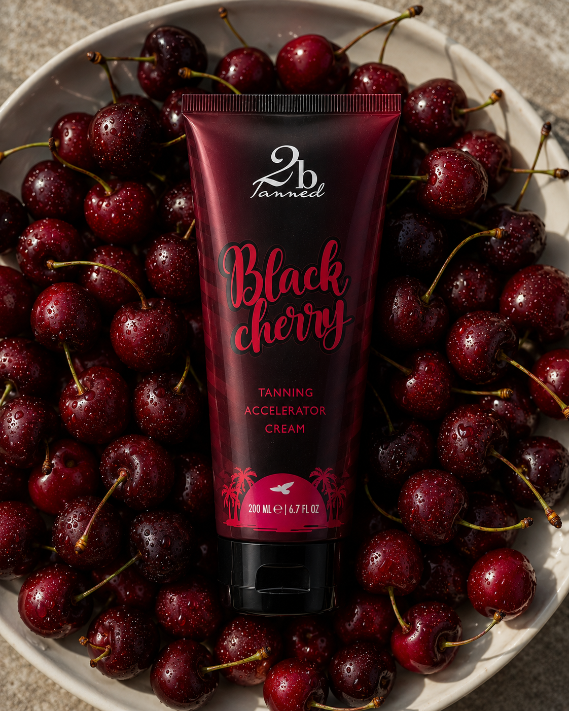 2BTanned Black Cherry Tanning Accelerator Cream in bowl of cherries – cherry scented tanning lotion 200ml